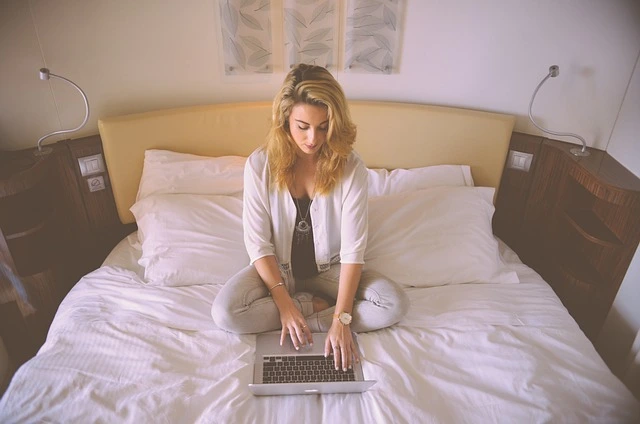 high value woman sitting in bed